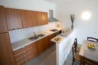 A kitchen or kitchenette at "Il Segreto" Vista Panoramica sulle Isole Eolie con Piscina, palestra e WiFi