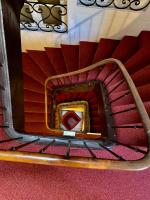 a spiral staircase in a building with red carpet at Hotel Wilson Square in Toulouse