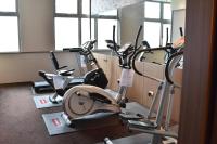 a gym with several exercise bikes in a room at Hotel Intrendy in Taishan