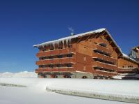 a large building with snow on the roof at Le Vancouver in La Plagne