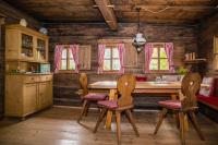 a kitchen with a table and chairs in a cabin at Tradlhof in Thierbach