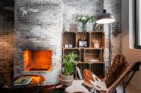 a living room with a brick wall and a fireplace at 9Hotel Bastille-Lyon in Paris