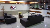 a waiting room with two couches and a counter at JR Hotel in João Pessoa