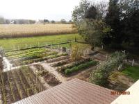 a garden with a field in the background at Les Galets in Tracy-sur-Mer