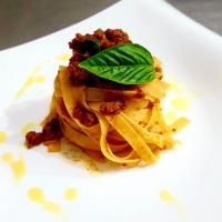 a plate of pasta with a basil leaf on top at Hotel El Dorado in La Romana