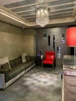 a living room with a couch and a red chair at Beauty Hotels Taipei - Hotel B7 in Taipei