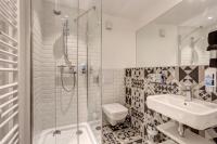 a bathroom with a shower and a toilet and a sink at MEININGER Hotel Paris Porte de Vincennes in Paris