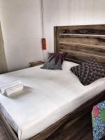 a large white bed with pillows on top of it at Siki Hotel in Saint-Louis