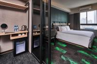 a hotel room with a bed and a desk at Kung Shang Design Hotel in Kaohsiung