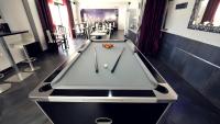 a pool table in the middle of a room at Citotel Hôtel Le Capricorne in Marmande