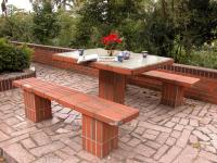 a picnic table and two benches on a brick patio at Relax heart B&amp;B in Dongshan