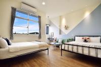 a bedroom with two beds and a window at Piau Po 21 Inn in Taitung City