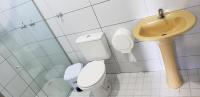 a bathroom with a toilet and a sink at JR Hotel in João Pessoa