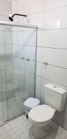 a bathroom with a toilet and a glass shower at JR Hotel in João Pessoa