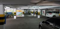 a parking garage with cars parked in it at JR Hotel in João Pessoa