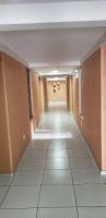 an empty hallway in a building with a tile floor at JR Hotel in João Pessoa