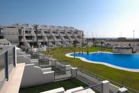 a large apartment building with a large swimming pool at Casa Valdevaqueros in Tarifa