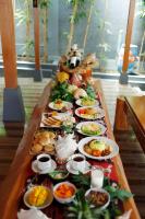 a long table with many plates of food on it at Pavilla Labuan Bajo in Labuan Bajo