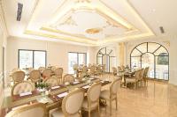 a large dining room with long tables and chairs at Phu Cuong Hotel Ca Mau in Cà Mau