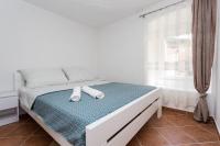 Postel nebo postele na pokoji v ubytování Apartmani Obala