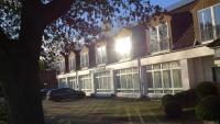 a building with a car parked in front of it at Hotel Heidpark in Lüneburg