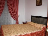 a bedroom with a bed with red curtains at Casa Rural La Verdura in Ubrique