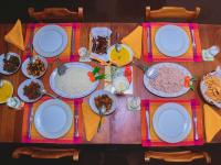 een houten tafel met borden met eten erop bij Thalpe Walawwa Heritage Villa With Private Beach Access in Unawatuna