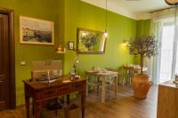 a room with green walls and tables and chairs at il Palchetto B&amp;B di Charme e Design in Palermo