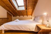 a bedroom with a large white bed with a window at Apartment Capucin in Chamonix