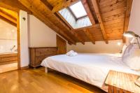 a bedroom with a large bed and a wooden ceiling at Apartment Capucin in Chamonix