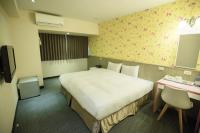 a hotel room with a large bed and a desk at Ximen Relite Hotel in Taipei