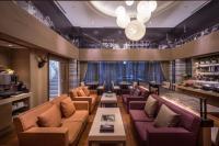 a bar with couches and tables in a room at Green World JianPei in Taipei