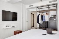 a room with a bed and a laptop on a table at Delamar 4*Sup-Adults only (18+) in Lloret de Mar