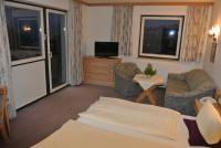 A television and/or entertainment centre at Hotel Gruberhof Innsbruck Igls B&B