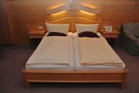 A bed or beds in a room at Hotel Gruberhof Innsbruck Igls B&B