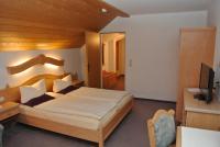 A bed or beds in a room at Hotel Gruberhof Innsbruck Igls B&B