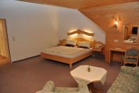 A bed or beds in a room at Hotel Gruberhof Innsbruck Igls B&B