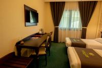 a hotel room with a desk and a bed at Magus Hotel in Baia Mare