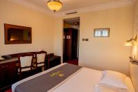 a hotel room with a bed and a desk at Magus Hotel in Baia Mare