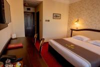a hotel room with a bed and a desk at Magus Hotel in Baia Mare