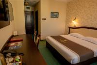 a hotel room with a bed and a desk at Magus Hotel in Baia Mare