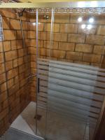 a shower with a glass door in a bathroom at Las 4 Lunas in Zahara de la Sierra