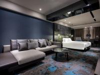 a hotel room with a bed and a couch at Kung Shang Design Hotel in Kaohsiung