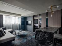 a living room with a large marble counter in a room at Kung Shang Design Hotel in Kaohsiung