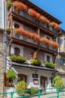 un edificio con muchas flores en los balcones en Hotel Fonda Merce, en Llivia