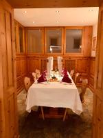 a dining room with a white table and chairs at Albana Hotel Silvaplana in Silvaplana