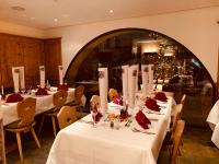 a dining room with white tables and a large mirror at Albana Hotel Silvaplana in Silvaplana