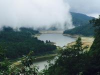 a lake in the middle of a valley with trees at Bei Yue B&amp;B in Luodong