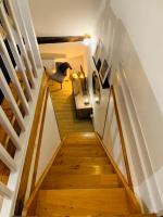 a wooden staircase with a chair in a room at La maison de Nina in Sens