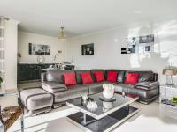 a living room with a leather couch and red pillows at Apartment Les Pins D&#39;Alep by Interhome in Le Cannet
